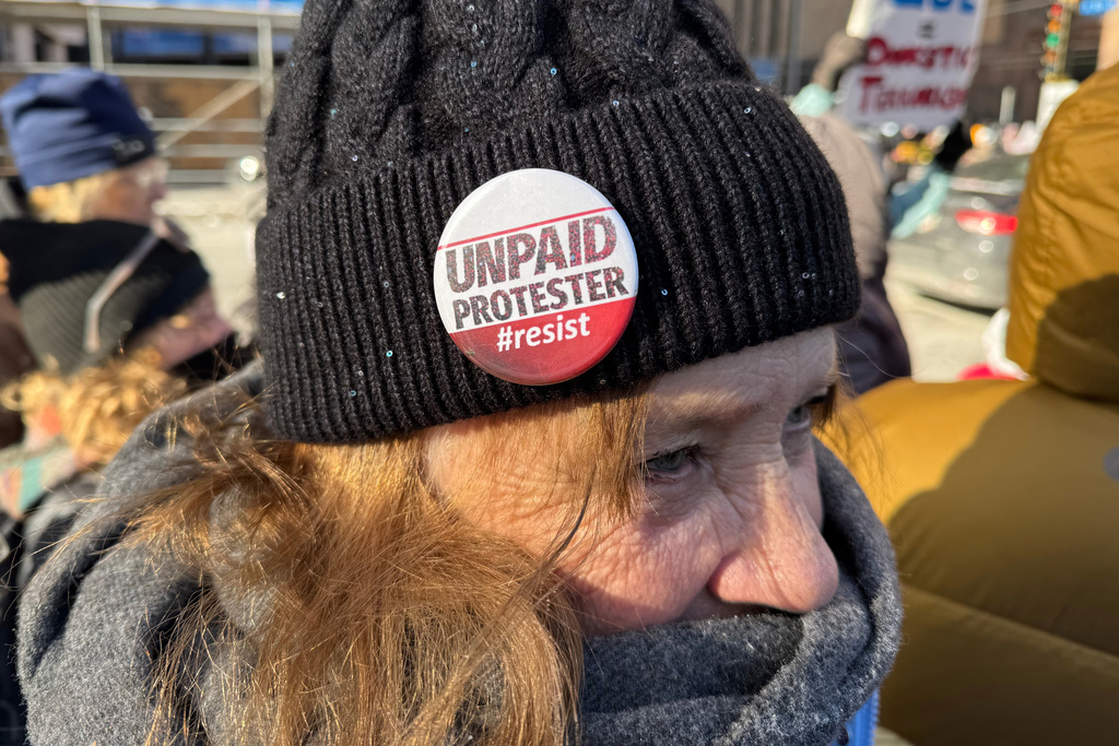 People participate in an anti-ICE rally Sunday, Jan. 25, 2026, in Minneapolis. (AP Photo/Jack Brook)