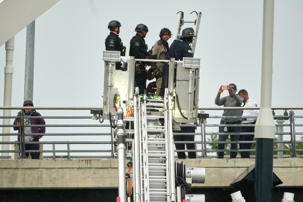 Emergency personnel remove Guido Reichstadter, 45, off the Frederick Douglass Bridge, Wednesday, May 6, 2026 in Washington. Reichstadter, who scaled to the top of the Frederick Douglass Bridge in Washington last week, has come down, after his 6-day protest. (AP Photo/Julia Demaree-Nikhinson)