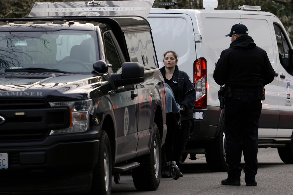 One of the victims is removed as authorities investigate the scene after reports that a man fatally stabbed multiple people Tuesday, Feb. 24, 2026, in Gig Harbor, Wash. (AP Photo/John Froschauer)