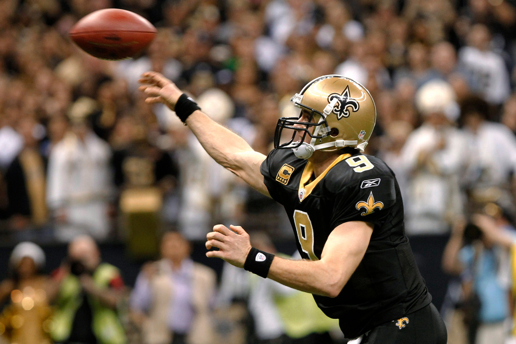FILE - New Orleans Saints quarterback Drew Brees throws a touchdown pass during the fourth quarter of an NFL football game against the Atlanta Falcons in New Orleans, Dec. 26, 2011. (AP Photo/Rusty Costanza, File)