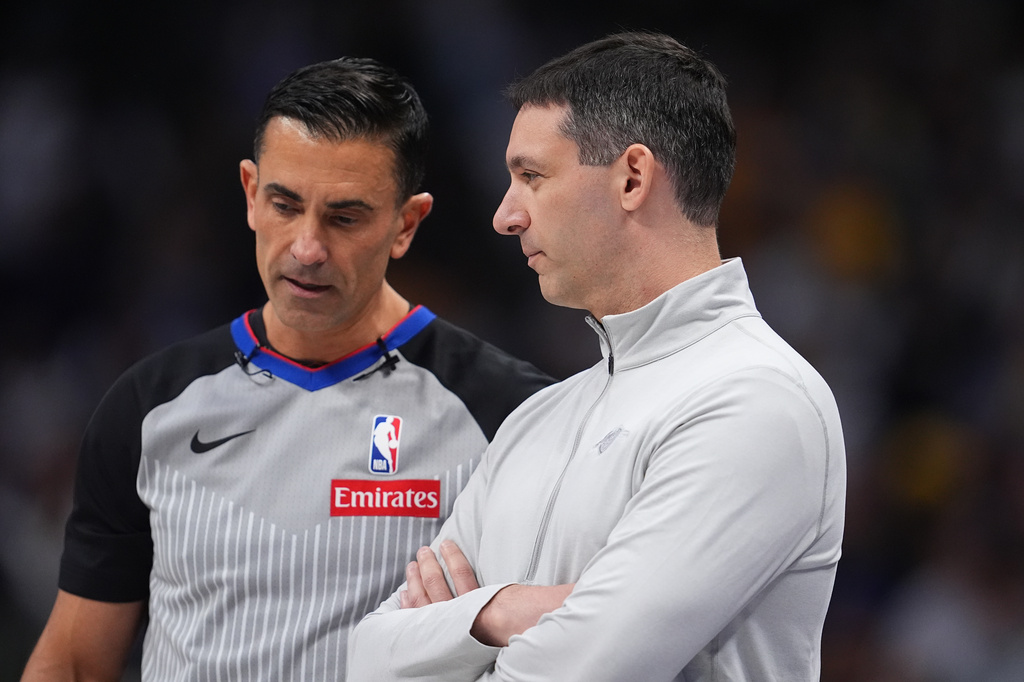 Oklahoma City Thunder head coach Mark Daigneault, front, confers with referee Zach Zarba in the first half of an NBA basketball game against the Denver Nuggets Friday, April 10, 2026, in Denver. (AP Photo/David Zalubowski)