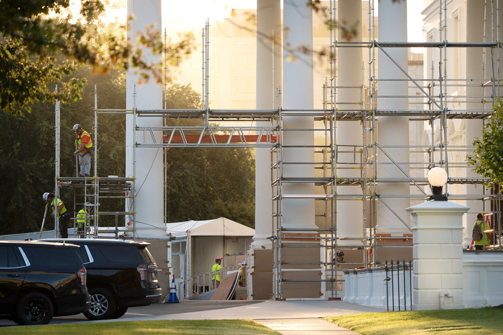 Workers remove scaffolding from columns at the North Portico of the White House, Tuesday, Sept. 8, 2026, in Washington. (AP Photo/Mark Schiefelbein)