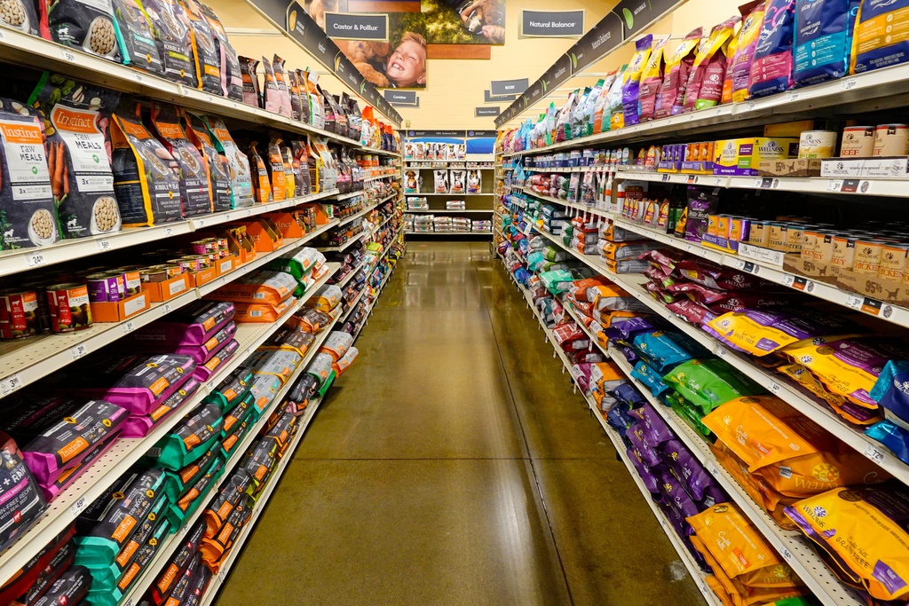 FILE - Dog food sits on shelves in a pet store in Westfield, Ind., July 19, 2022. (AP Photo/Michael Conroy, File)
