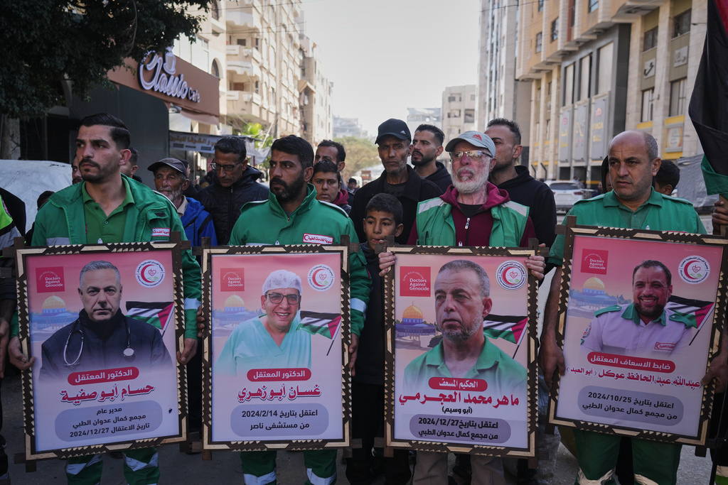 Medical staff take part in a protest organized by the Palestinian Prisoners Committee calling for the release of prisoners held in Israeli prisons outside the Red Cross headquarters in Gaza City Monday, Jan. 12, 2026. (AP Photo/Jehad Alshrafi)