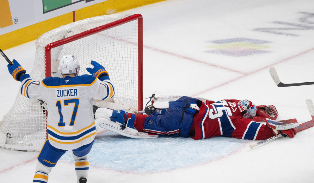 Buffalo Sabres' Jason Zucker (17) celebrates a goal by teammate Konsta Helenius in front of Montreal Canadiens goaltender Jakub Dobes (75) during the second period in Game 6 in a second-round NHL hockey Stanley Cup playoff series in Montreal, Saturday, May 16, 2026. (Christinne Muschi/The Canadian Press via AP)