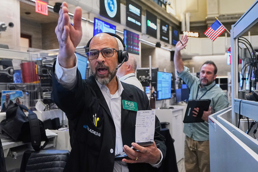 Options traders Steven Rodriguez, left, and Scott Frenzy work on the floor of the New York Stock Exchange, Friday, Nov. 14, 2025. (AP Photo/Richard Drew)