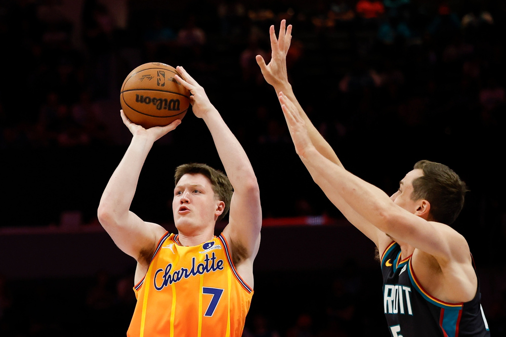 Charlotte Hornets guard Kon Knueppel (7) looks to shoot against Detroit Pistons forward Duncan Robinson, right, during the first half of an NBA basketball game in Charlotte, N.C., Friday, April 10, 2026. (AP Photo/Nell Redmond)