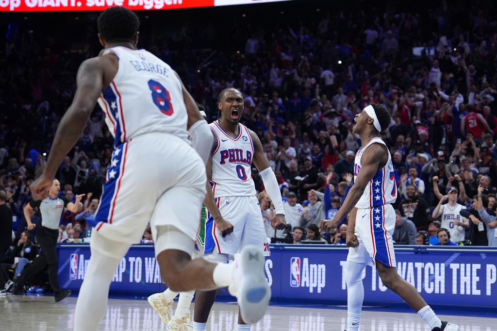 Philadelphia 76ers' Tyrese Maxey (0), Vj Edgecombe (77) and Paul George (8) celebrate during the second half of Game 6 in a first-round NBA basketball playoff series against the Boston Celtics Thursday, April 30, 2026, in Philadelphia. (AP Photo/Matt Slocum)