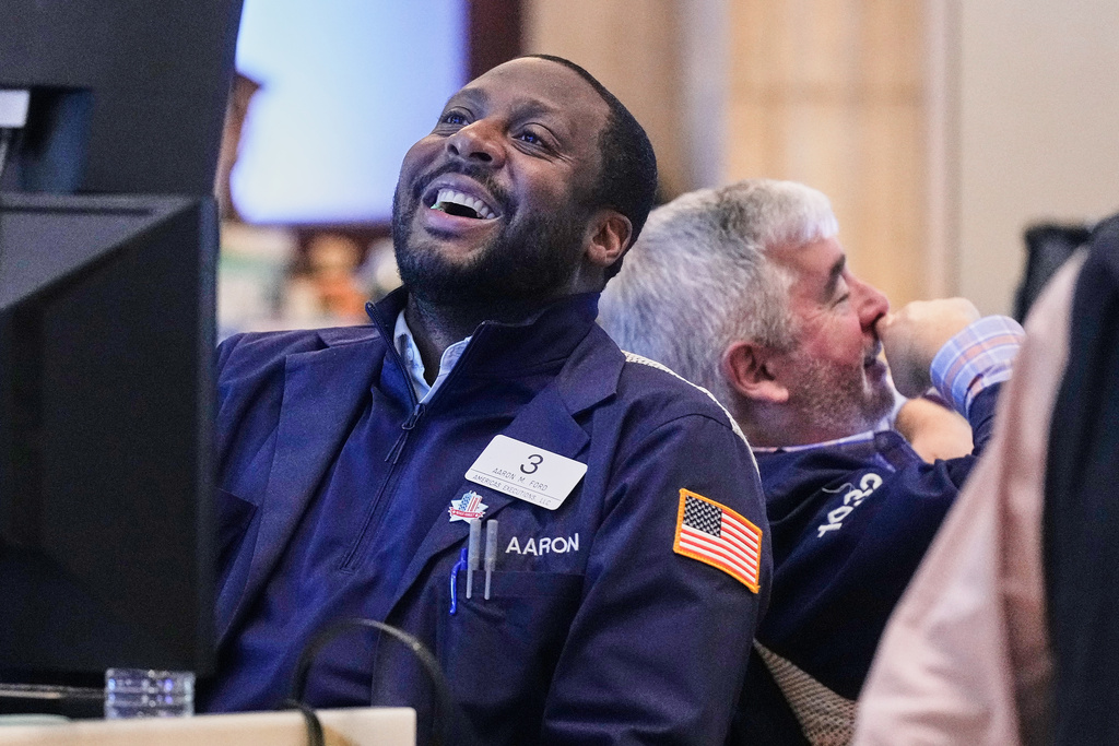 Traders Aaron Ford, left, and James McCarthy work on the floor of the New York Stock Exchange, Friday, Nov. 21, 2025. (AP Photo/Richard Drew)