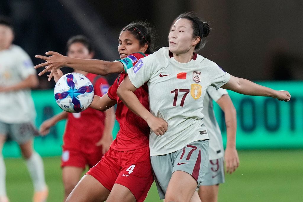 China's Xie Zongmei, right, and Bangladesh's Afeida Khandaker compete for the ball during the Women's Asia Cup soccer match between China and Bangladesh in Sydney, Tuesday, March 3, 2026. (AP Photo/Rick Rycroft)