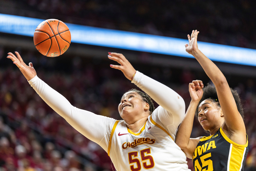 Iowa State center Audi Crooks (55) catches the ball in the post as Iowa forward Hannah Stuelke, right, defends during an NCAA college basketball game in Ames, Iowa, Wednesday, Dec. 10, 2025. (Nick Rohlman/The Gazette via AP)