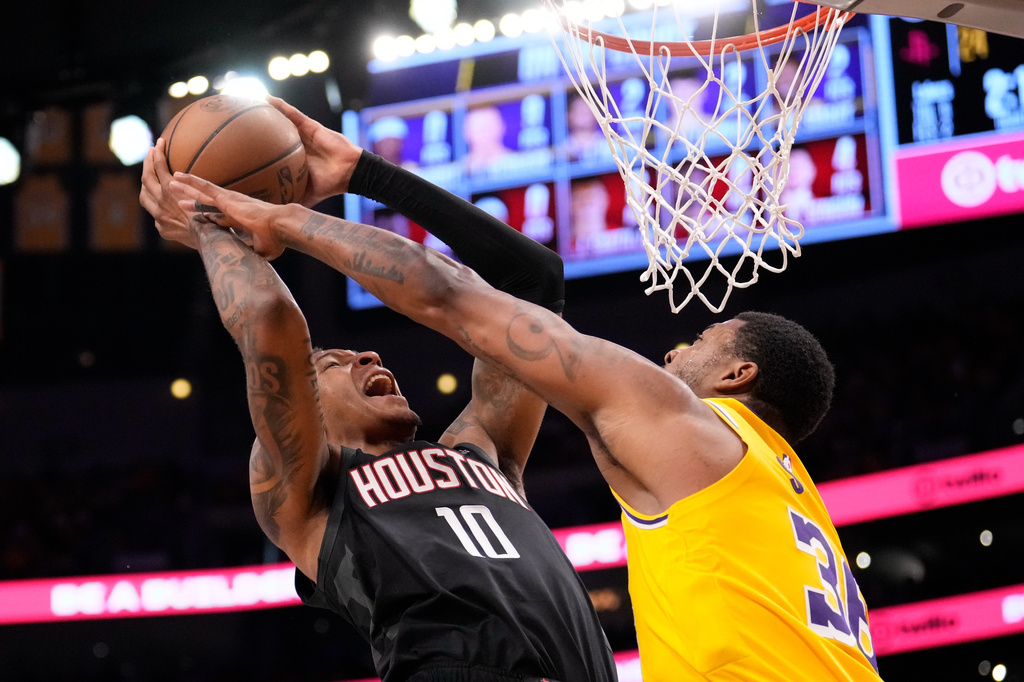 Houston Rockets forward Jabari Smith Jr., left, shoots as Los Angeles Lakers guard Marcus Smart defends during the first half in Game 1 of a first-round NBA playoffs basketball series Saturday, April 18, 2026, in Los Angeles. (AP Photo/Mark J. Terrill)