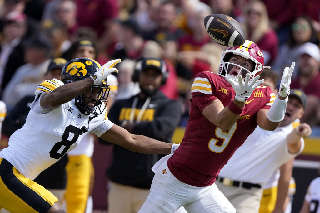 Iowa State wide receiver Brett Eskildsen (9) catches a pass over Iowa defensive back Deshaun Lee (8) during the first half of an NCAA college football game, Saturday, Sept. 6, 2025, in Ames, Iowa. (AP Photo/Charlie Neibergall)