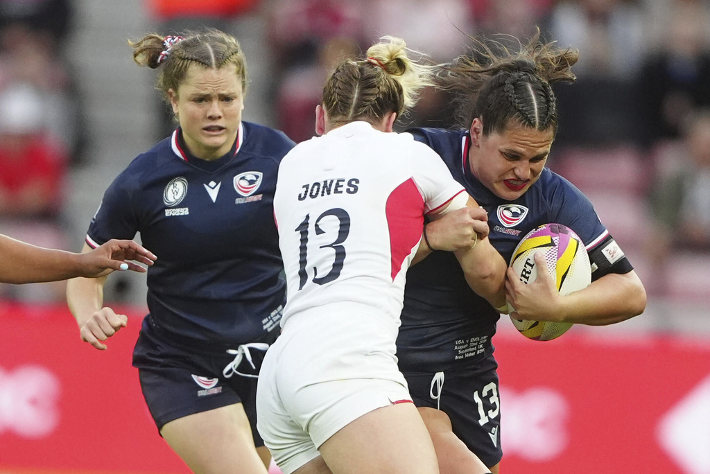 USA's Ilona Maher, right, is tackled by England's Megan Jones during the group A match at the 2025 Women's Rugby World Cup between England and the United States in Sunderland, England, Friday, Aug. 22, 2025. (Owen Humphreys/PA via AP)