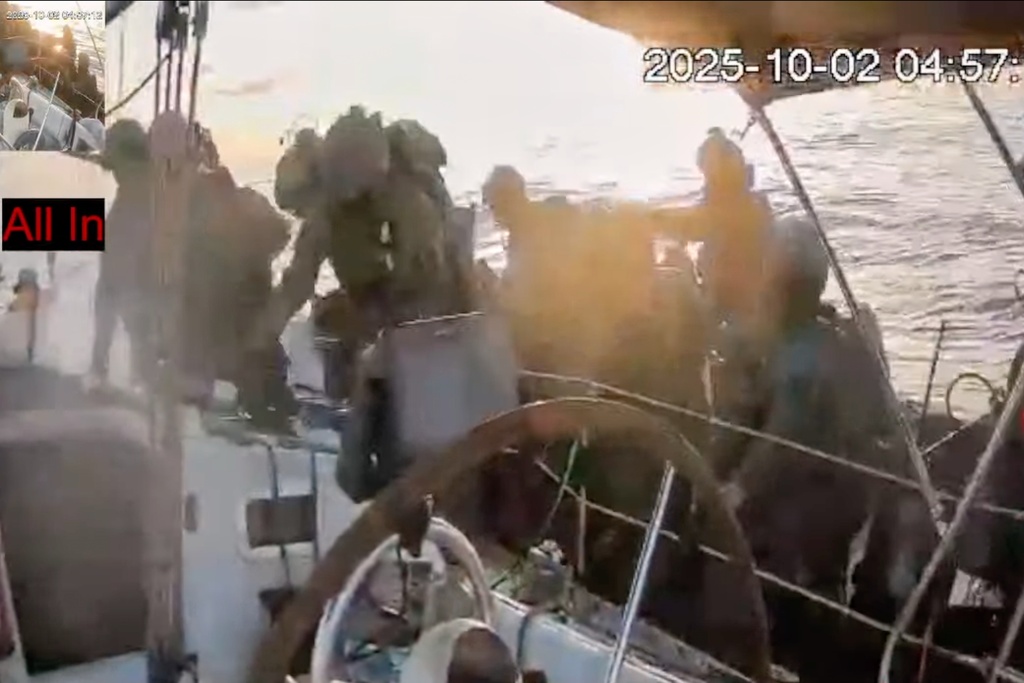 This frame grab from video released by the Global Sumud Flotilla shows Israeli navy soldiers boarding one of the flotilla's vessels as it approached the coast of Gaza early Thursday, Oct. 2, 2025. (Global Sumud Flotilla via AP)