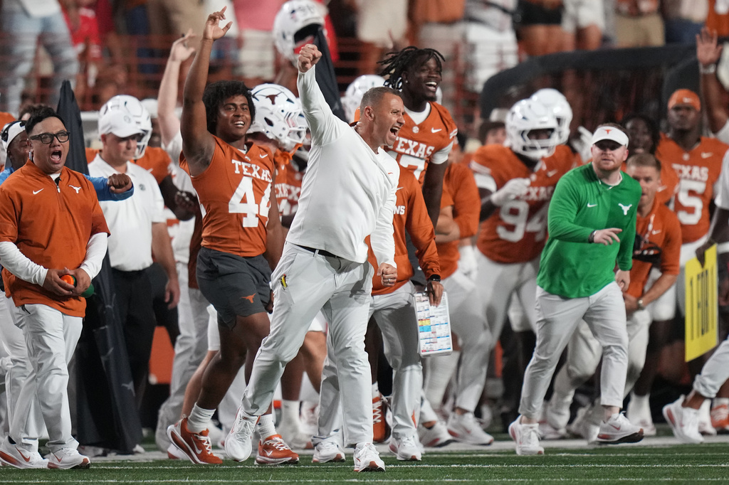 Texas head coach Steve Sarkisian, center, celebrates Texas' win over Ohio State in an NCAA college football game in Austin, Texas, Saturday, Sept. 12, 2026. (AP Photo/Eric Gay)