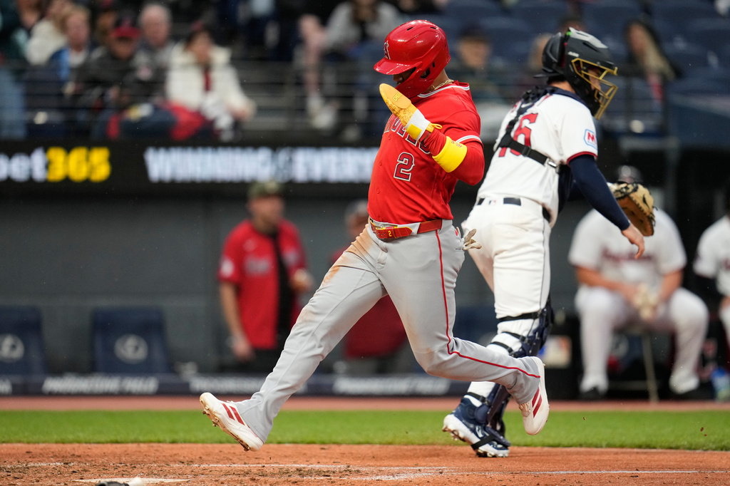 Los Angeles Angels' Oswald Peraza, left, scores behind Cleveland Guardians catcher Patrick Bailey, right, in the sixth inning of a baseball game in Cleveland, Tuesday, May 12, 2026. (AP Photo/Sue Ogrocki)