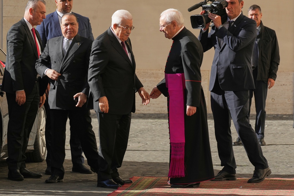 Palestinian President Mahmoud Abbas, also known as Abu Mazen, left, is welcomed by Monsignor Leonardo Sapienza as he arrives in the St. Damasus Courtyard at the Vatican for a meeting with Pope Leo XIV, Thursday, Nov. 6, 2025. (AP Photo/Andrew Medichini)