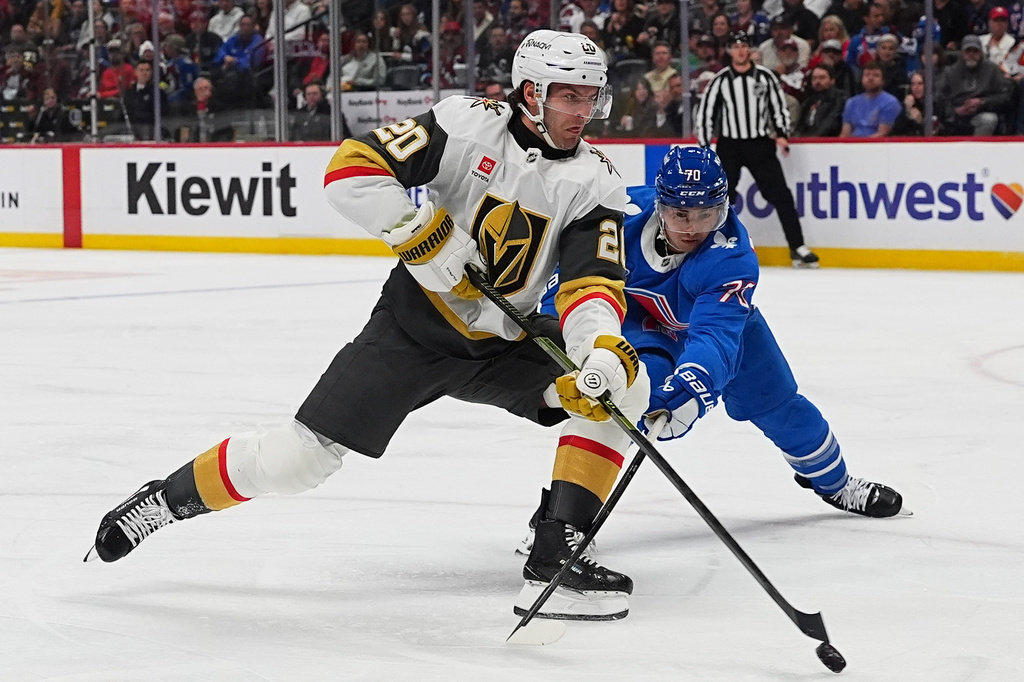 Vegas Golden Knights left wing Brandon Saad (20) drives past Colorado Avalanche defenseman Sam Malinski (70) in the second period of an NHL hockey game Saturday, April 11, 2026, in Denver. (AP Photo/David Zalubowski)