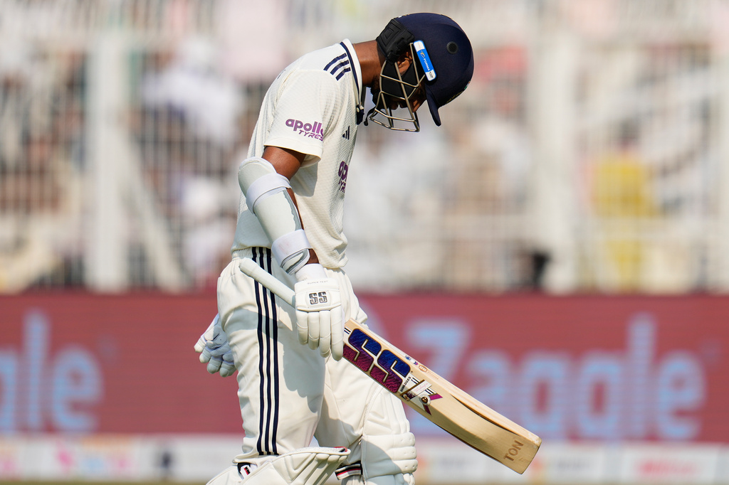 India's Washington Sundar reacts as he walks off the field after losing his wicket on the third day of the first cricket test match between India and South Africa in Kolkata, India, Sunday, Nov. 16, 2025. (AP Photo/Aijaz Rahi)