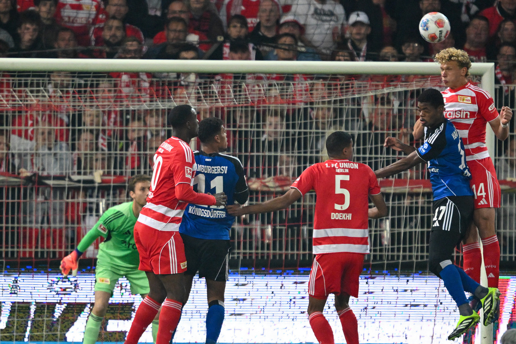 Berlin's Leopold Querfeld, right, and Hamburger's Warmed Omari go for a header during the Bundesliga soccer match between FC Union Berlin and Hamburger SV in Berlin, Sunday Sept. 28, 2025. (Soeren Stache/dpa via AP)