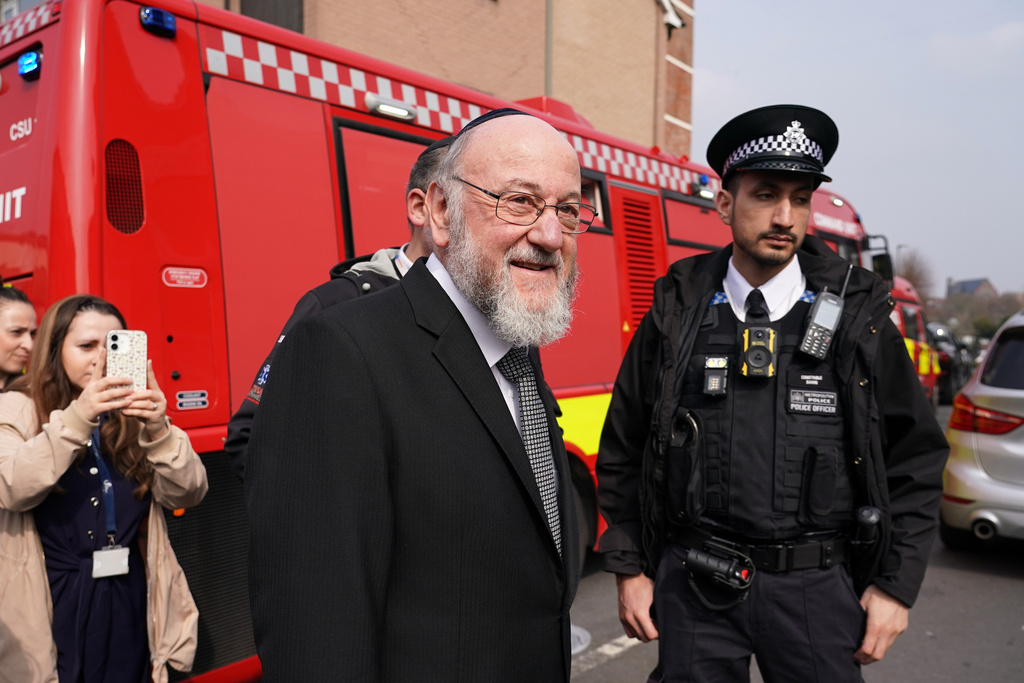 Chief Rabbi Ephraim Mirvis visits the site after an apparent arson attack on four vehicles belonging to a Jewish ambulance service, Hatzola Northwest, in London, Monday, March 23, 2026.(AP Photo/Alberto Pezzali)