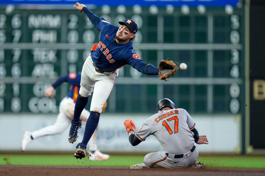 Baltimore Orioles' Colton Cowser (17) steals second as Houston Astros second baseman Raynel Delgado, left, misses the throw during the fourth inning of a baseball game Sunday, July 19, 2026, in Houston. (AP Photo/Eric Christian Smith)