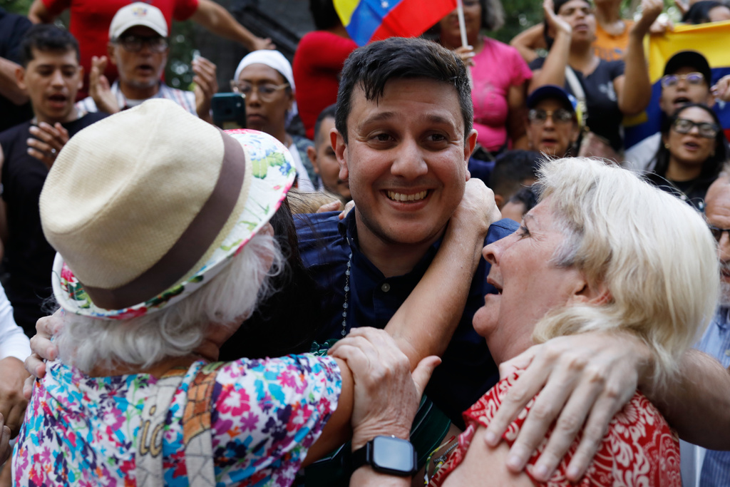 Political activist Jesus Armas is embraced by opposition supporters after his release from prison in Caracas, Venezuela, Sunday, Feb. 8, 2026. (AP Photo/Cristian Hernandez)