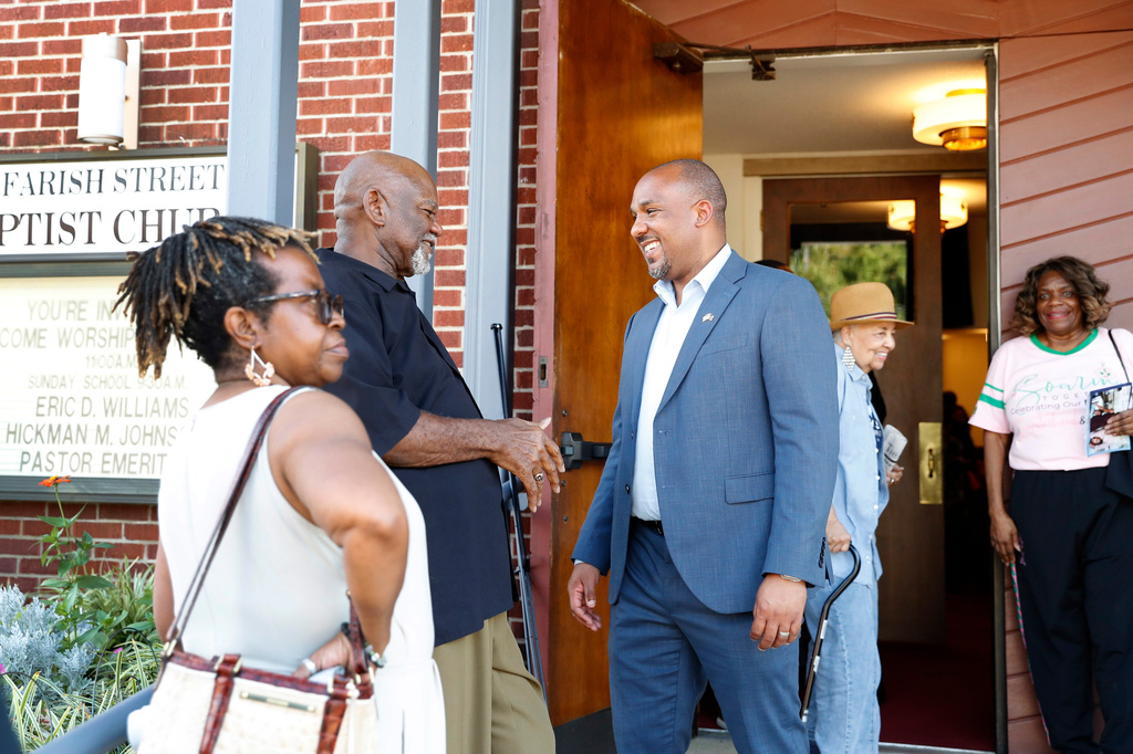 Mississippi Democratic U.S. Senate candidate Scott Colom, center, speaks with an attendee of a voting rights town hall at the historic Farish Street Baptist Church in Jackson, Miss., Saturday, Aug. 1, 2026. (AP Photo/Sarah Warnock)