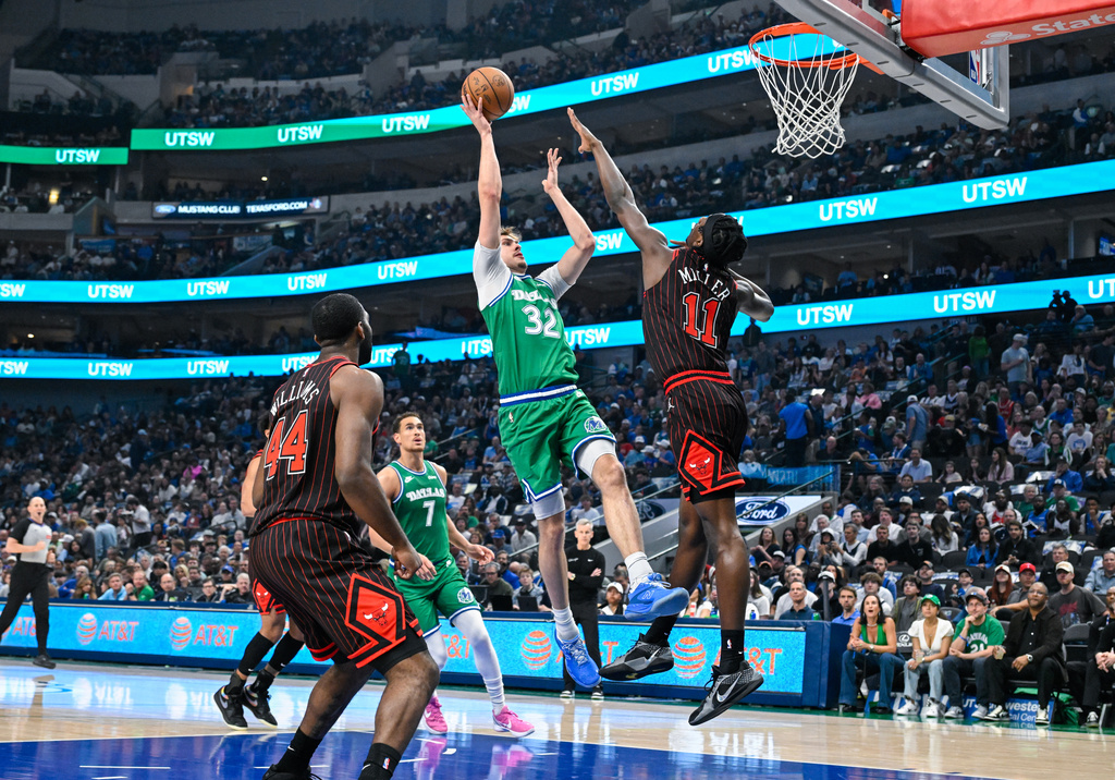 Dallas Mavericks' Cooper Flagg goes up to shoot during an NBA basketball game over Chicago Bulls' Leonard Miller Sunday, April 12, 2026, in Dallas. (AP Photo/Albert Pena)