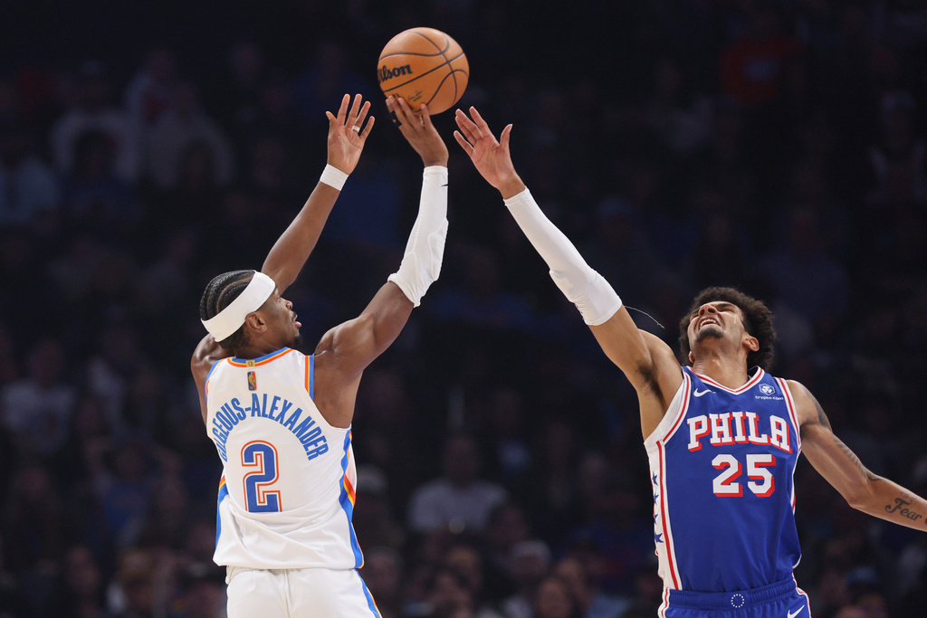 Oklahoma City Thunder guard Shai Gilgeous-Alexander (2) shoots over Philadelphia 76ers forward Dominick Barlow (25) during the first half of an NBA basketball game Sunday, Dec. 28, 2025, in Oklahoma City. (AP Photo/Nate Billings)