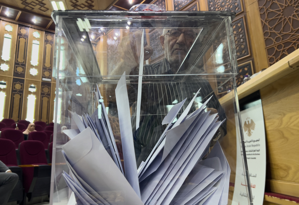 A Syrian electoral college member casts his vote during a parliamentary election at Latakia's Governor ballot station in Latakia, Syria, Sunday, Oct. 5, 2025. (AP Photo/Hussein Malla)