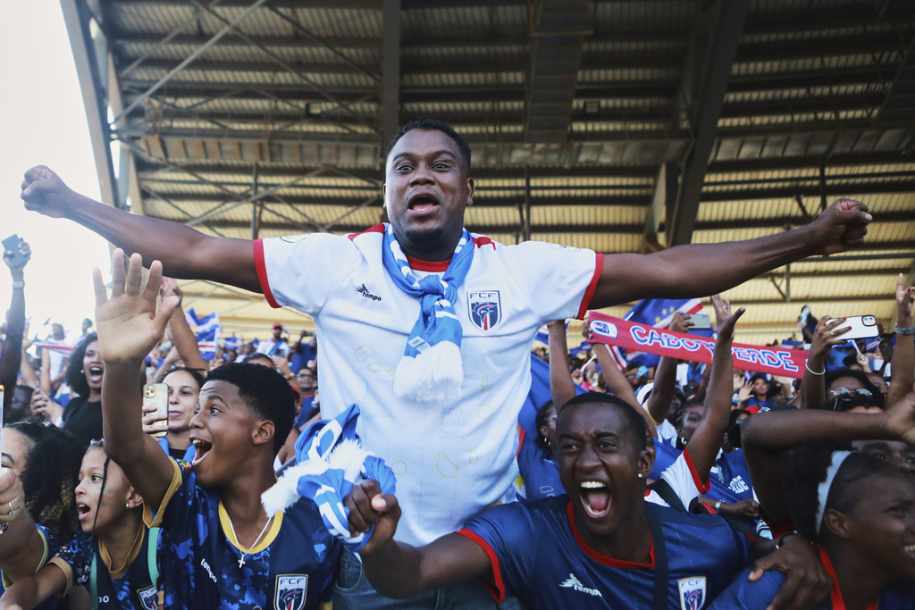 Fans celebrate in the stands after Cape Verde defeated Eswatini in a World Cup qualifying soccer match at Estádio Nacional in Praia, Cape Verde, Monday, Oct. 13, 2025, to clinch their qualification for the 2026 World Cup. (AP Photo/Cristiano Barbosa)