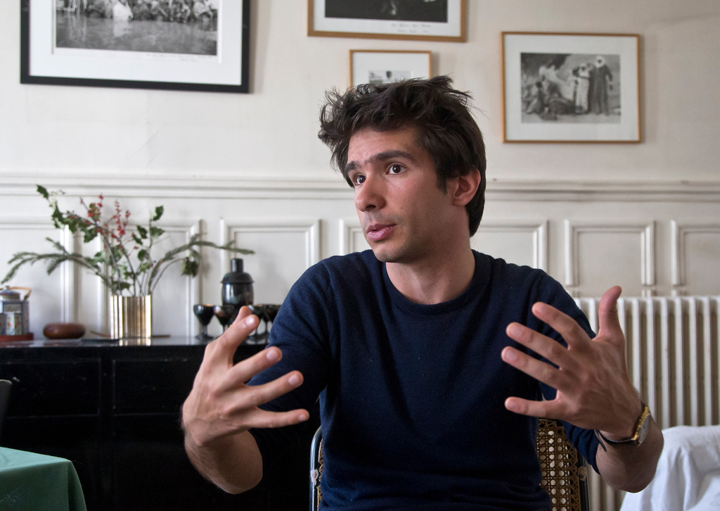 FILE - Lawyer Juan Branco, who co-authored a legal document alleging crimes against humanity by the European Union, speaks during an interview with The Associated Press, April 11 2019, in Paris, France. (AP Photo/Michel Euler, File)