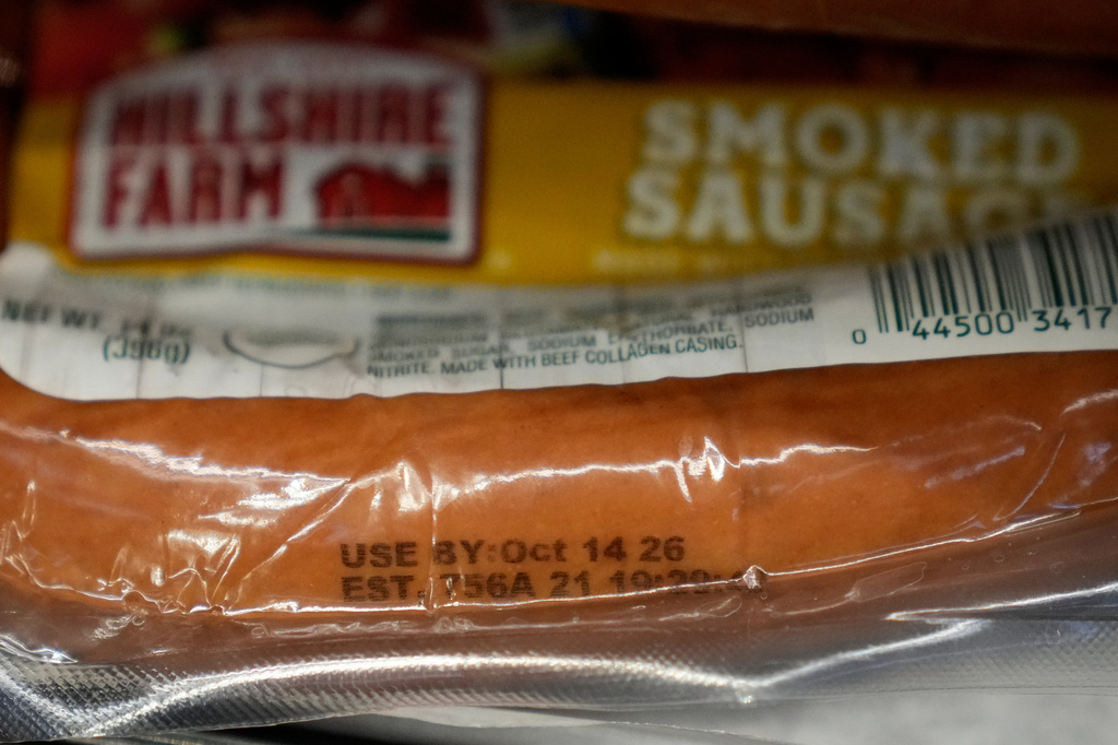 A Use By date is stamped on package of smoke sausage displayed at Park Plaza Fine Foods, Tuesday, June 30, 2026, in San Francisco. (AP Photo/Jeff Chiu)