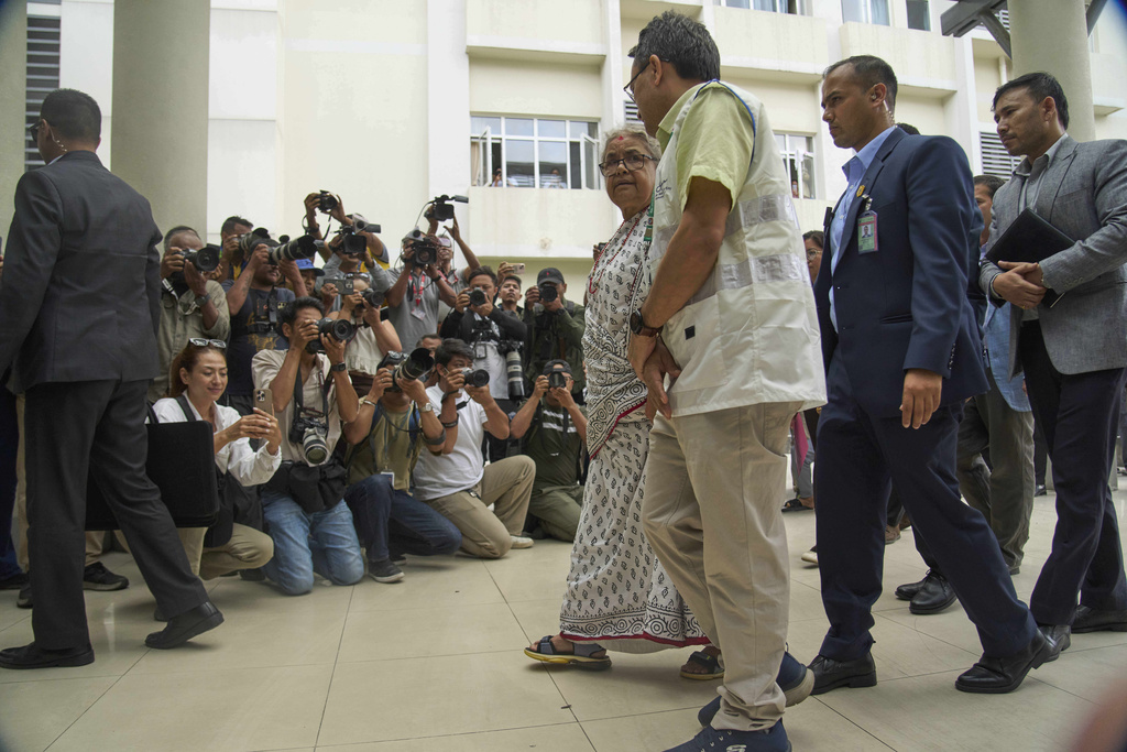 Nepal's interim prime minister Sushila Karki, center, speaks to doctor at Civil hospital as she arrives to meet people injured during anti-corruption protests sparked by a short-lived social media ban in Kathmandu, Nepal, Saturday, Sept. 13, 2025. (AP Photo/Niranjan Shrestha)