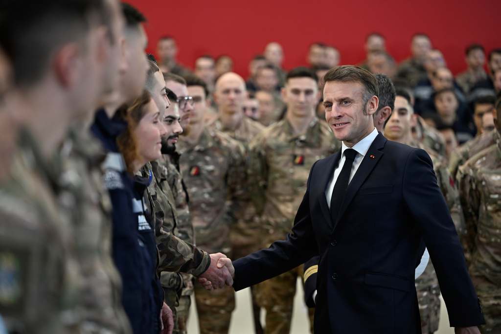 French President Emmanuel Macron shakes with soldiers as he visits the Istres military air force base, southern France, Thursday, Jan. 15, 2026. (AP Photo/Philippe Magoni, Pool)