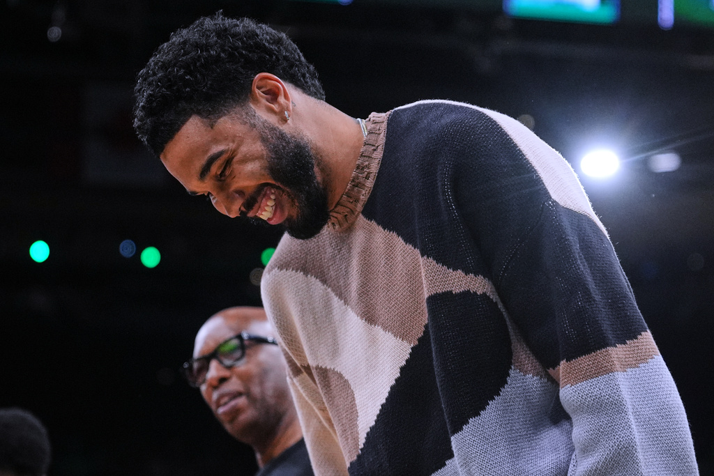 Boston Celtics forward Jayson Tatum, right, jokes with assistant coach Sam Cassell during the first half of an NBA basketball game against the Brooklyn Nets, Friday, Feb. 27, 2026, in Boston. (AP Photo/Charles Krupa)