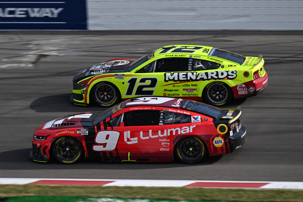 Ryan Blaney (12) and Chase Elliott (9) compete during a NASCAR Cup Series auto race Sunday, Sept. 13, 2026, in Madison, Ill. (AP Photo/Connor Hamilton)