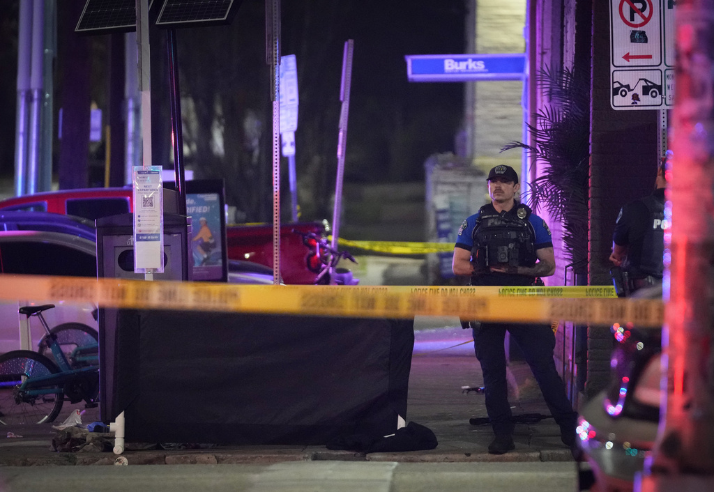 An Austin police officer guards the scene on West 6th Street at West Avenue after a shooting, Sunday March 1, 2026, in Austin, Texas. (Jay Janner/Austin American-Statesman via AP)