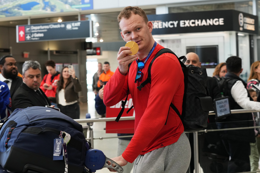 United States' hockey player Brady Tkachuk shows off his goal medal after arriving at Miami International Airport from the Milan Cortina Olympics, Monday, Feb. 23, 2026, in Miami. (AP Photo/Marta Lavandier)