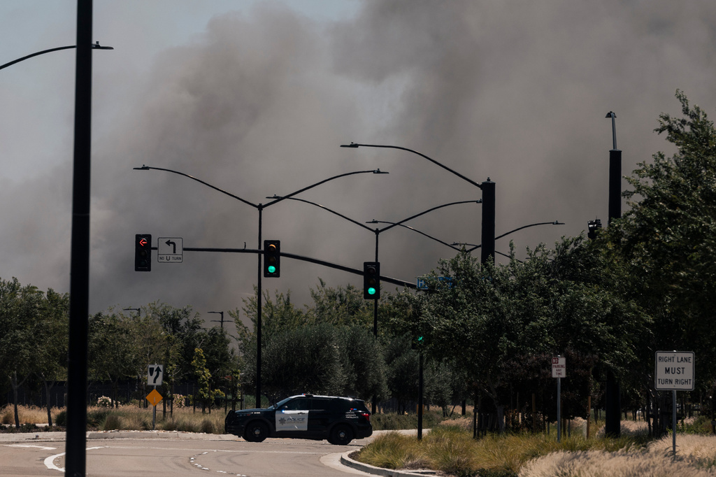 Smoke is seen from the massive fire at the Medline medical supply warehouse a million-foot facility, in Tracy, Calif., Friday, June 12, 2026. (Stephen Lam/San Francisco Chronicle via AP)