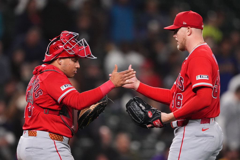 Los Angeles Angels catcher Moisés Ballesteros greets relief pitcher Ryan Watson as they celebrate a win over the Seattle Mariners in a baseball game, Thursday, Sept. 24, 2026, in Seattle. (AP Photo/Lindsey Wasson)