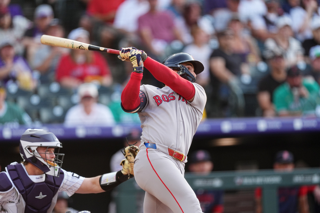 Boston Red Sox's Wilyer Abreu follows the flight of his RBI triple off Colorado Rockies starting pitcher Sean Sullivan in the first inning of a baseball game Tuesday, June 23, 2026, in Denver. (AP Photo/David Zalubowski)