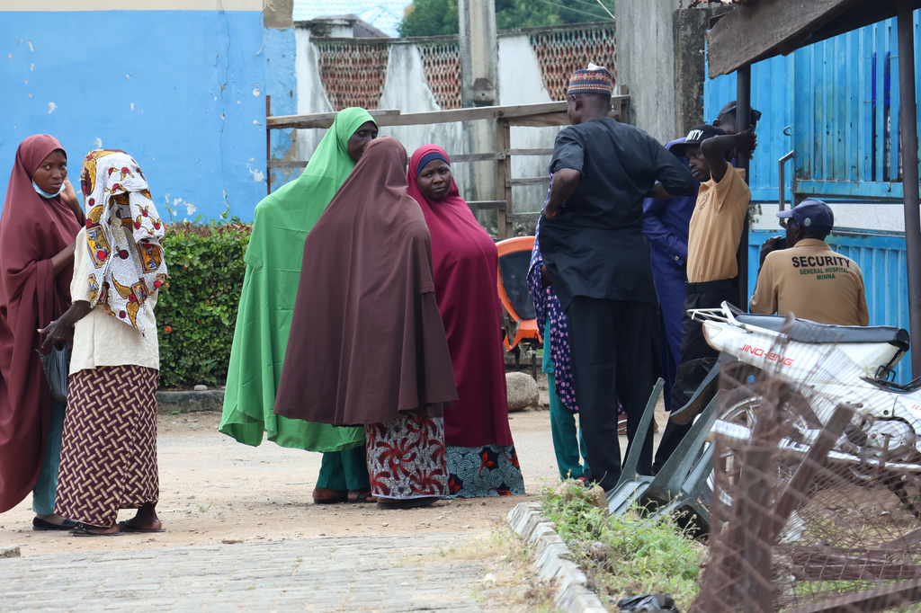 Families of miners who were arrested on suspicion of illegal mining and died in custody wait outside a hospital where their bodies are being held in Minna, Nigeria, Friday, Sept. 18, 2026. (AP Photo/Afolabi Sotunde)