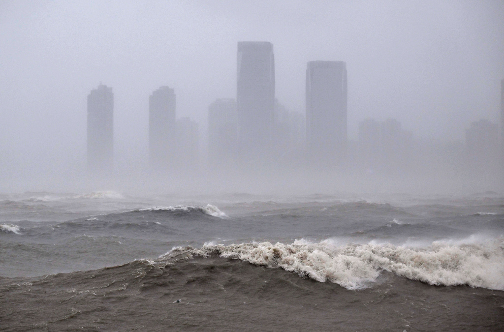 In this photo released by Xinhua News Agency, strong waves are seen ahead of Typhoon Matmo near the coastal downtown area of Haikou, in southern China's Hainan Province on Sunday, Oct. 5, 2025. (Guo Cheng/Xinhua via AP)