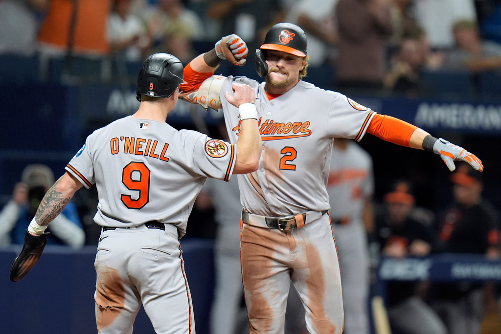 Baltimore Orioles' Gunnar Henderson (2) celebrates his two-run home run off Tampa Bay Rays pitcher Chris Roycroft with Tyler O'Neill (9) during the eighth inning of a baseball game Friday, Aug. 14, 2026, in St. Petersburg, Fla. (AP Photo/Chris O'Meara)