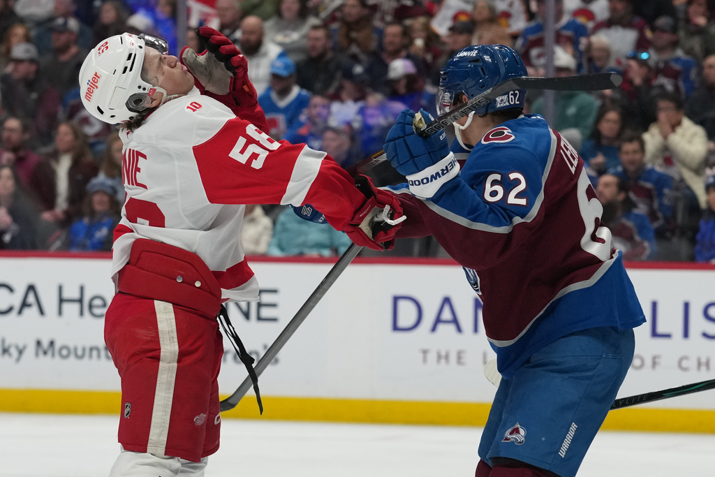 Detroit Red Wings center Emmitt Finnie, left, reacts after getting hit in the face by Colorado Avalanche left wing Artturi Lehkonen in the second period of an NHL hockey game, Monday, Feb. 2, 2026, in Denver. (AP Photo/David Zalubowski)