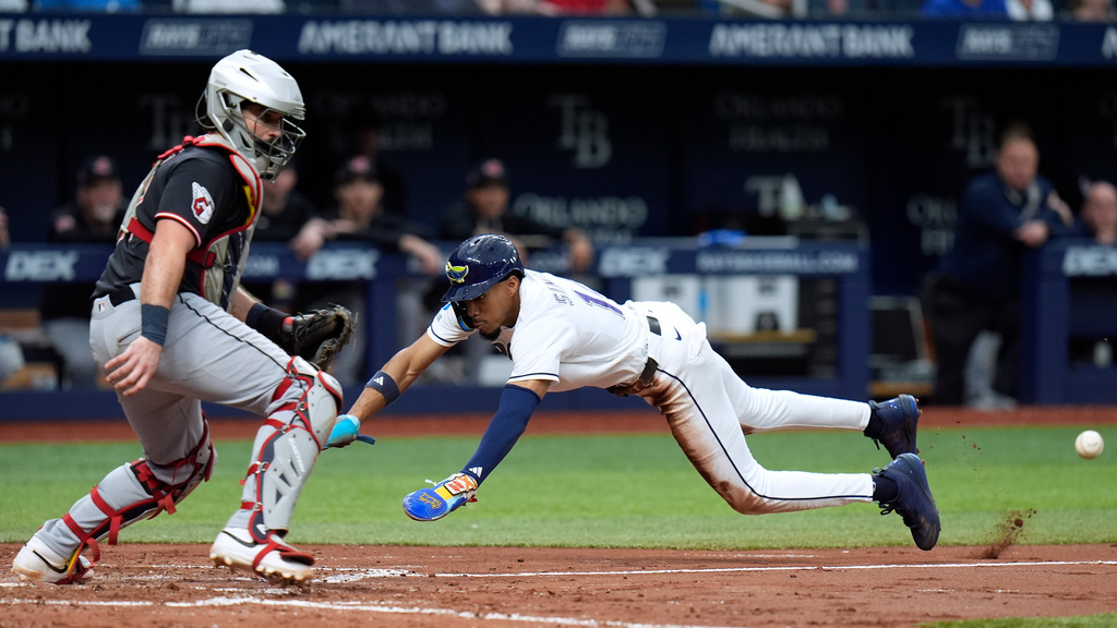Tampa Bay Rays' Chandler Simpson, right, scores ahead of the throw to Cleveland Guardians catcher Austin Hedges on a squeeze bunt by Cedric Mullins during the fifth inning of a baseball game Sunday, July 26, 2026, in St. Petersburg, Fla. (AP Photo/Chris O'Meara)