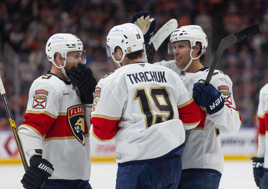Florida Panthers' Sam Bennett (9), Matthew Tkachuk (19) and Cole Reinhardt (29) celebrate a goal against the Edmonton Oilers during third period NHL action, in Edmonton on Thursday March 19, 2026. (Jason Franson/The Canadian Press via AP)